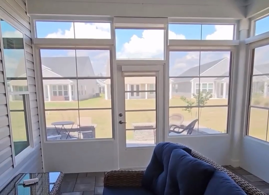 sunroom with motorized shades being lowered